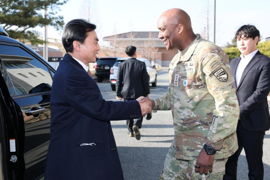 Defense Minister Ahn Gyu-back, left, shakes hands with Gen. Xavier Brunson, commander of the ROK-U.S. Combined Forces Co